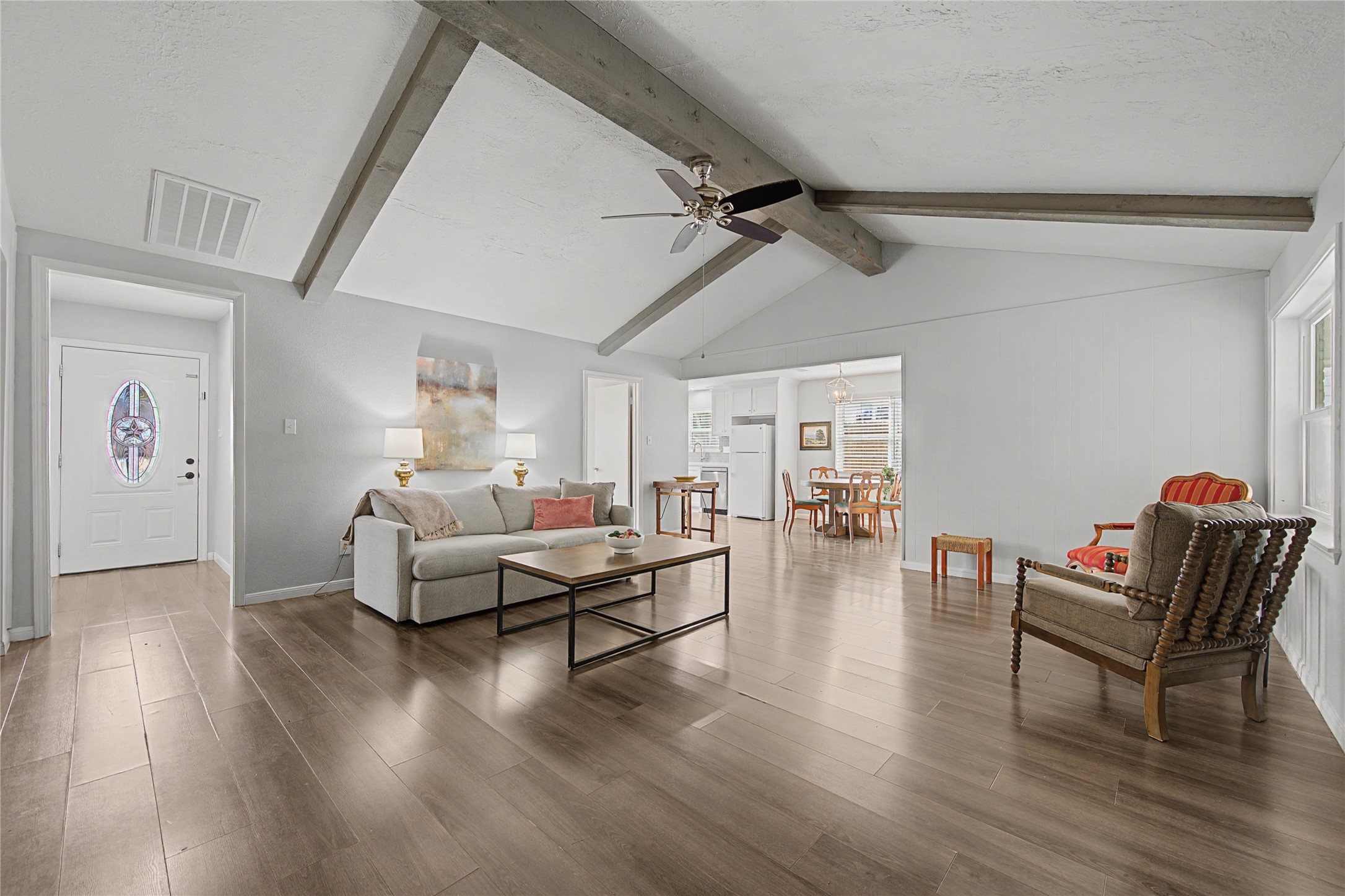 1719 Eastvale Drive Spring, TX 77386 - Photo 10 of 34 The open living area features exposed beam ceilings and neutral finishes. It's open to the breakfast area and the kitchen for added convenience.
