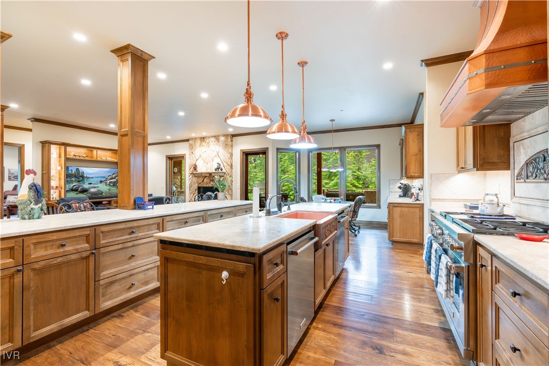 250 Pine Cone Road Incline Village, NV 89451 - Photo 12 of 50 a kitchen with kitchen island granite countertop a stove a sink a center island and a wooden floor