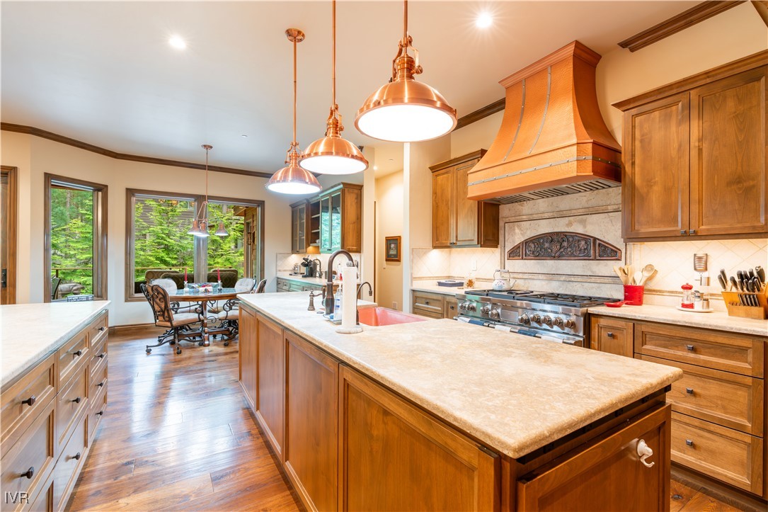 250 Pine Cone Road Incline Village, NV 89451 - Photo 13 of 50 a kitchen with a stove a sink dishwasher and a dining table with garden view
