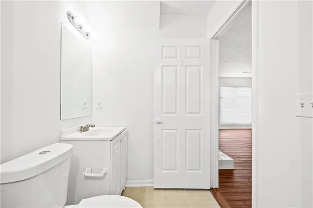 a bathroom with a sink a toilet and a mirror