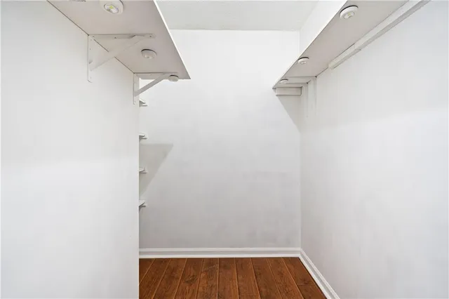 a view of walk in closet with empty racks