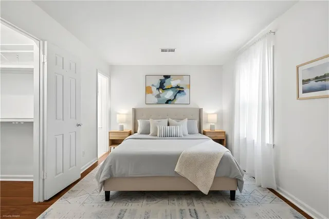 a bedroom with a bed and a painting on the wall