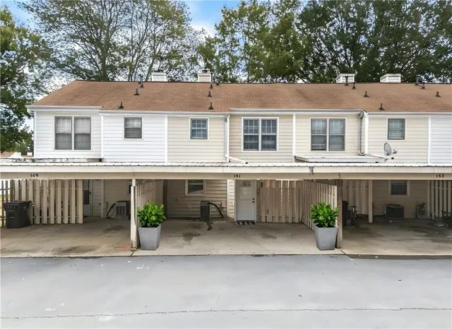 a front view of a house with a yard and a garage
