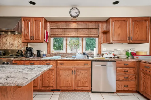 a kitchen with wooden cabinets and a sink