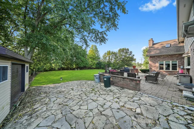 a view of a house with backyard porch and sitting area