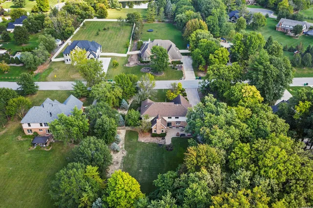 an aerial view of a house with a yard