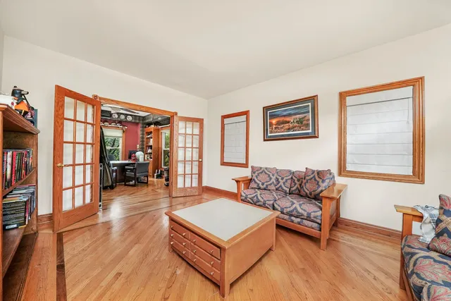 a living room with furniture and a book shelf