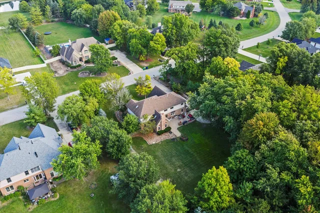 an aerial view of a house with a yard