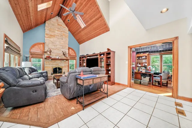 a living room with fireplace furniture and a window
