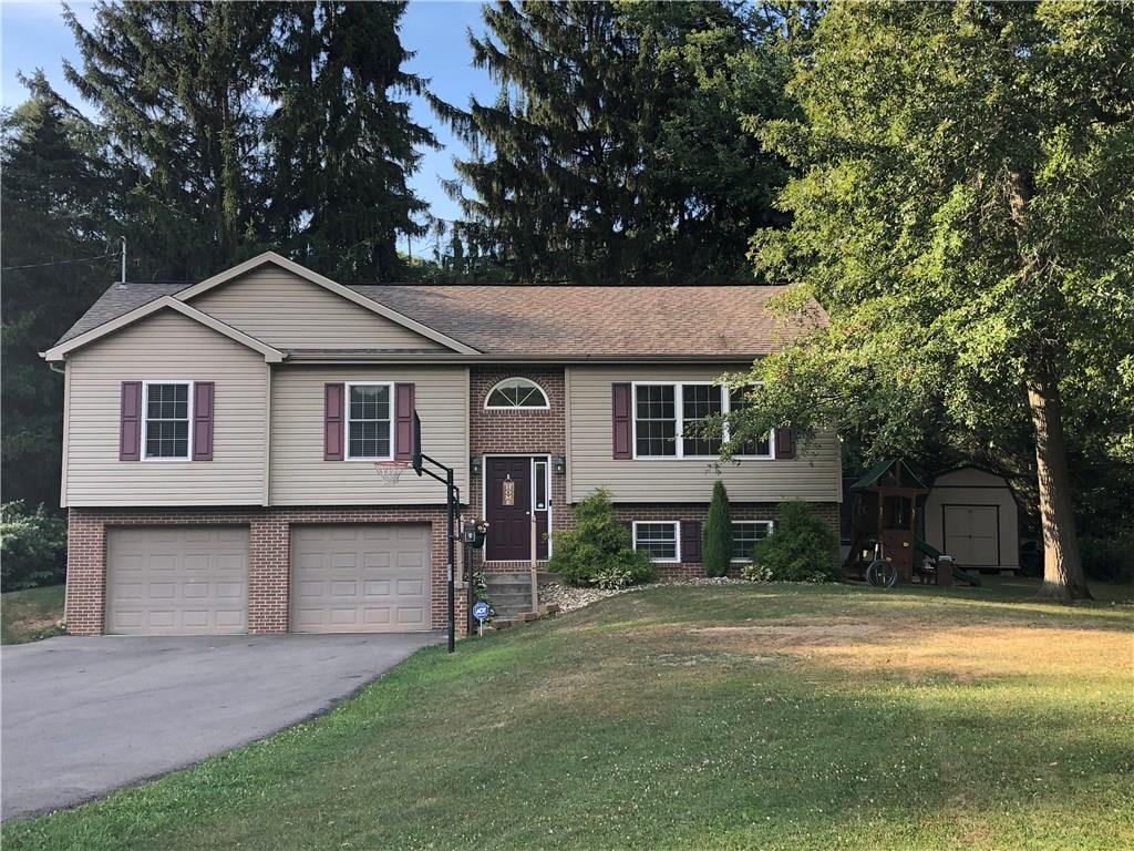 763 Oneida Valley Road Butler, PA 16001 - Photo 1 of 24 a front view of a house with a garden and trees