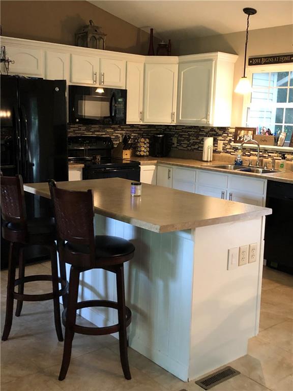 763 Oneida Valley Road Butler, PA 16001 - Photo 6 of 24 a kitchen with stainless steel appliances granite countertop a stove a sink and a microwave