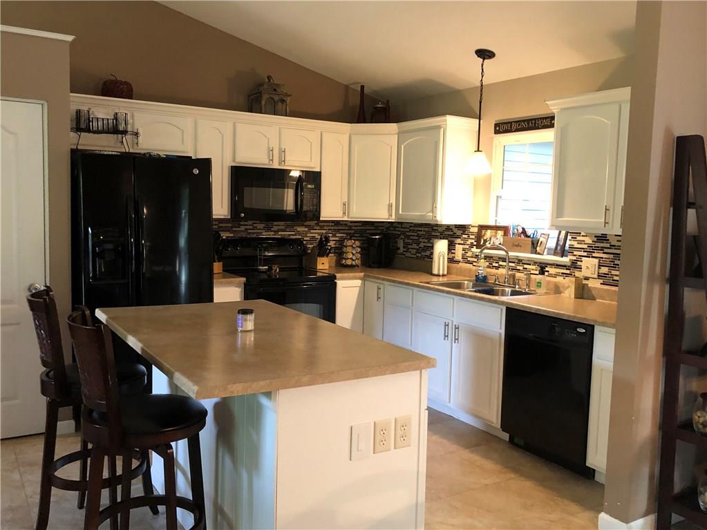 763 Oneida Valley Road Butler, PA 16001 - Photo 7 of 24 a kitchen with a stove a sink a microwave and a refrigerator