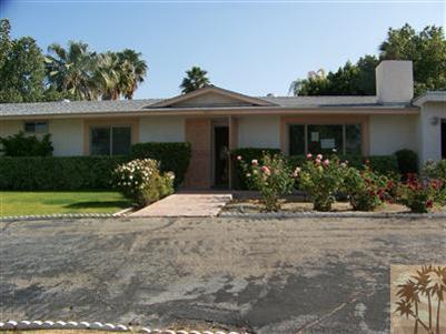 a front view of a house with a yard and a garage