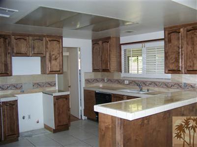 68431 Rodeo Road Cathedral City, CA 92234 - Photo 2 of 6 a kitchen with a sink stove and cabinets