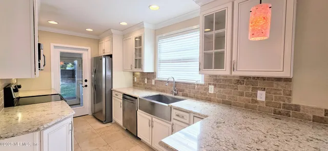 a kitchen with stainless steel appliances granite countertop a stove microwave and refrigerator
