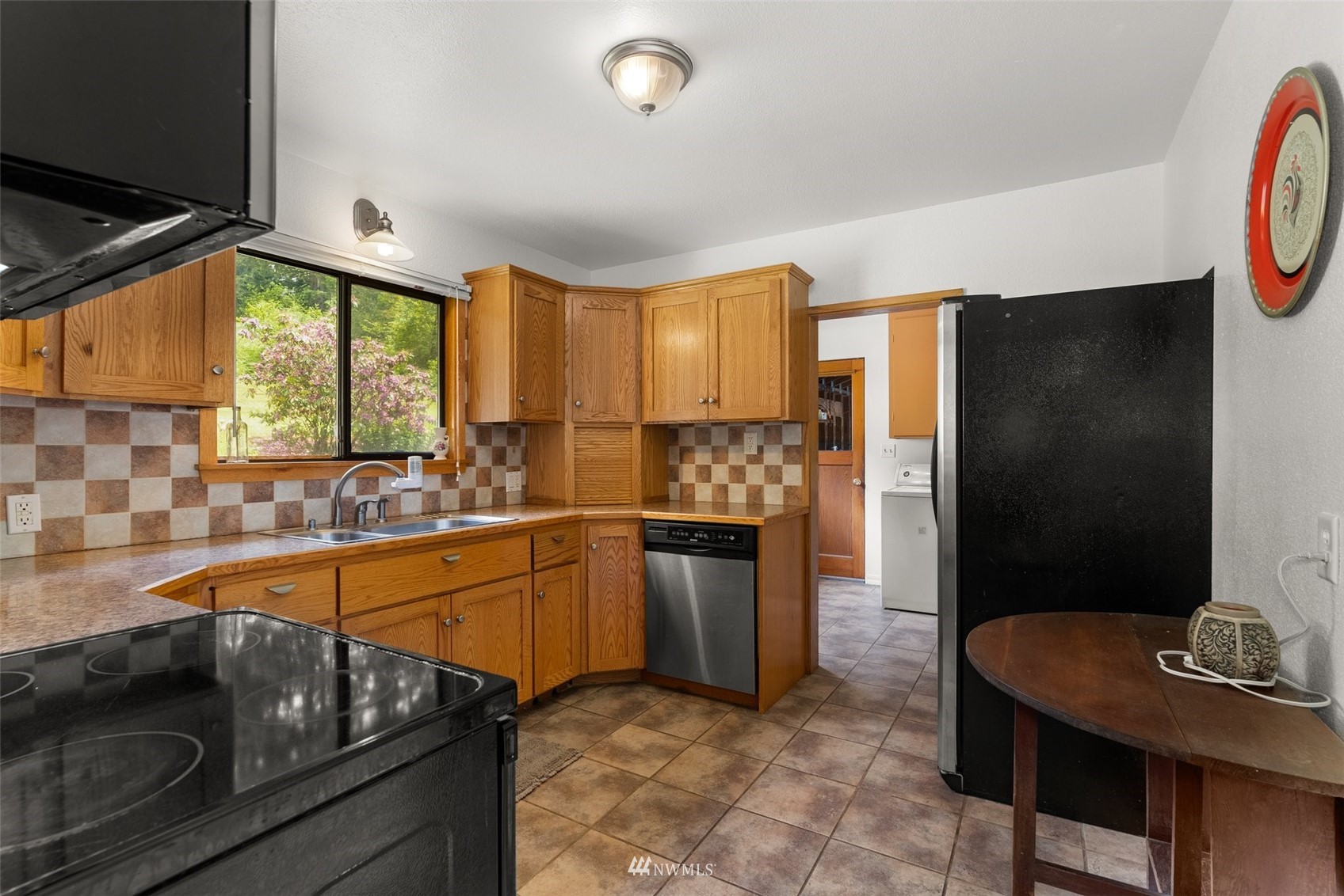 916 Southeast Korpi Way Winlock, WA 98596 - Photo 11 of 31 a kitchen with stainless steel appliances granite countertop a sink and a refrigerator
