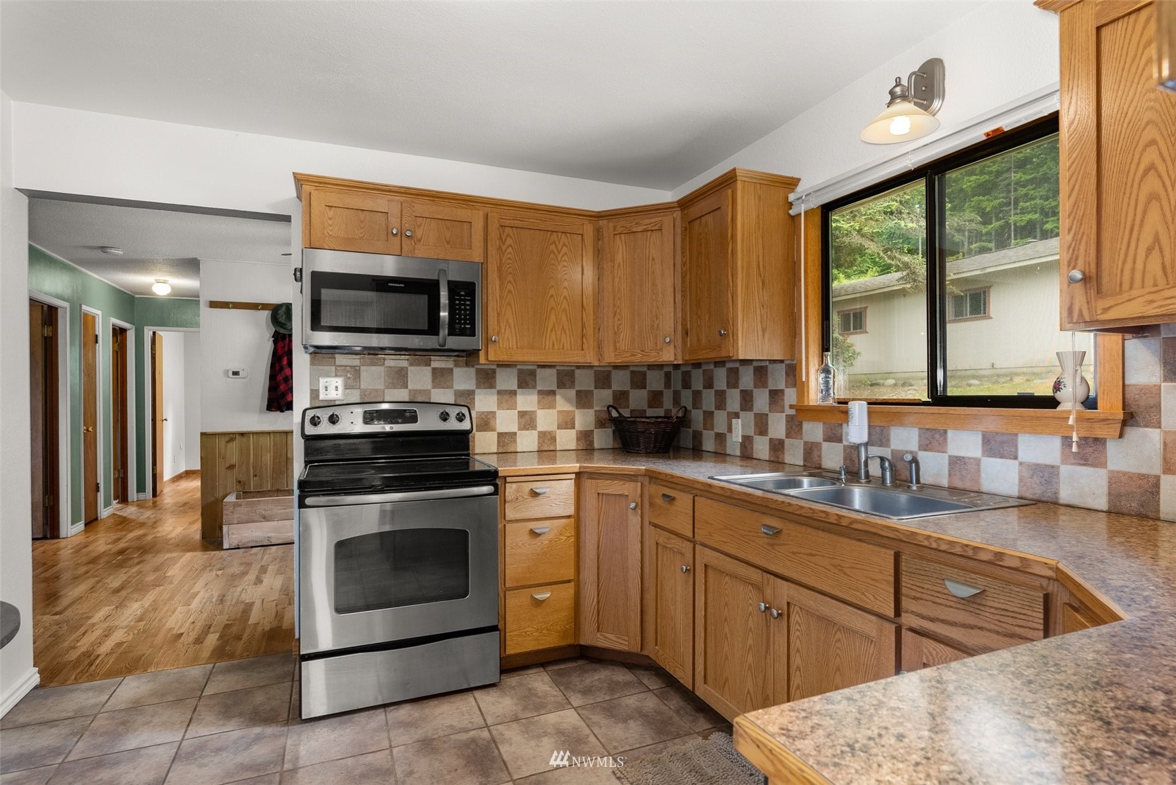 916 Southeast Korpi Way Winlock, WA 98596 - Photo 12 of 31 a kitchen with stainless steel appliances granite countertop a stove sink and microwave