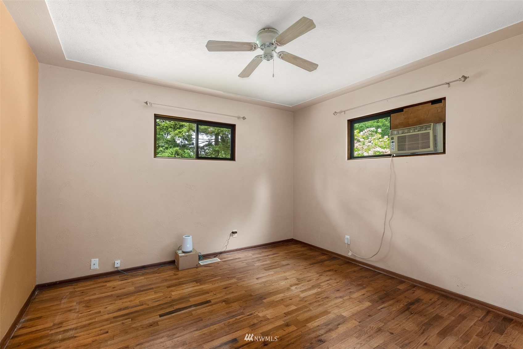 916 Southeast Korpi Way Winlock, WA 98596 - Photo 14 of 31 an empty room with wooden floor and windows