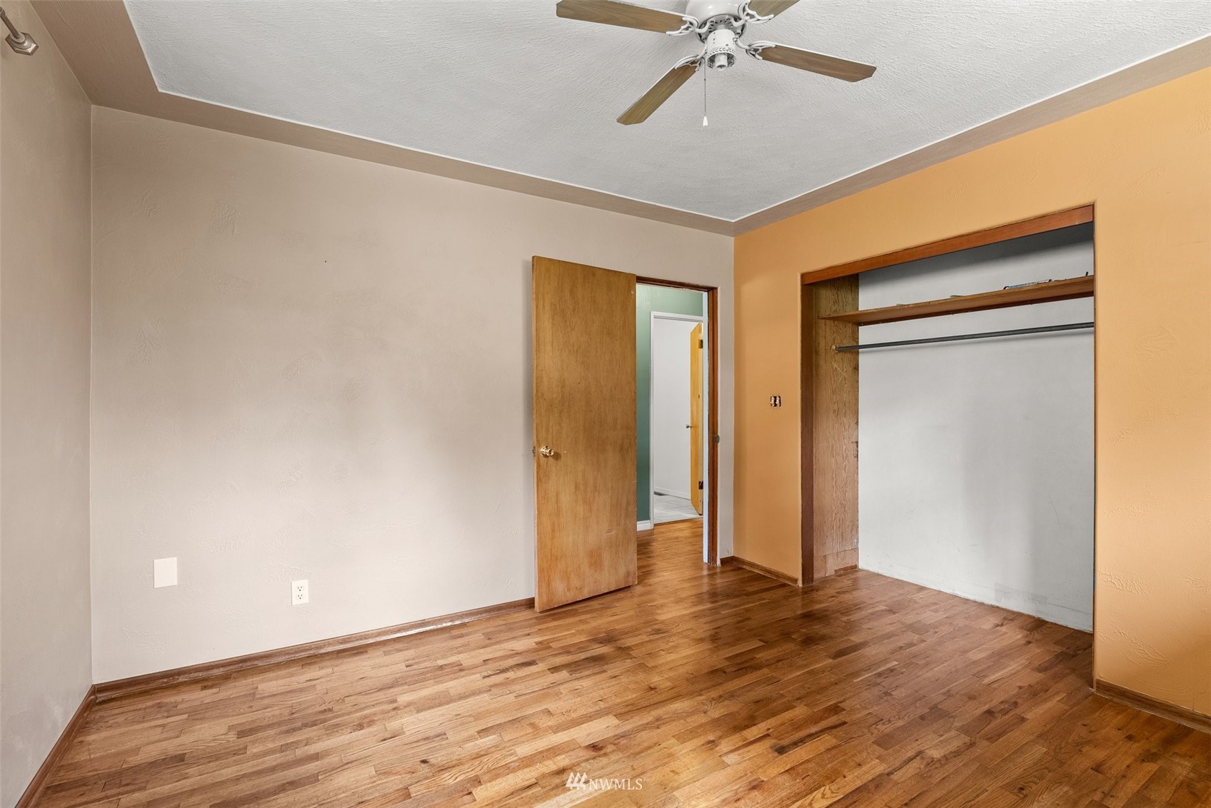 916 Southeast Korpi Way Winlock, WA 98596 - Photo 15 of 31 a view of an empty room with wooden floor and a ceiling fan