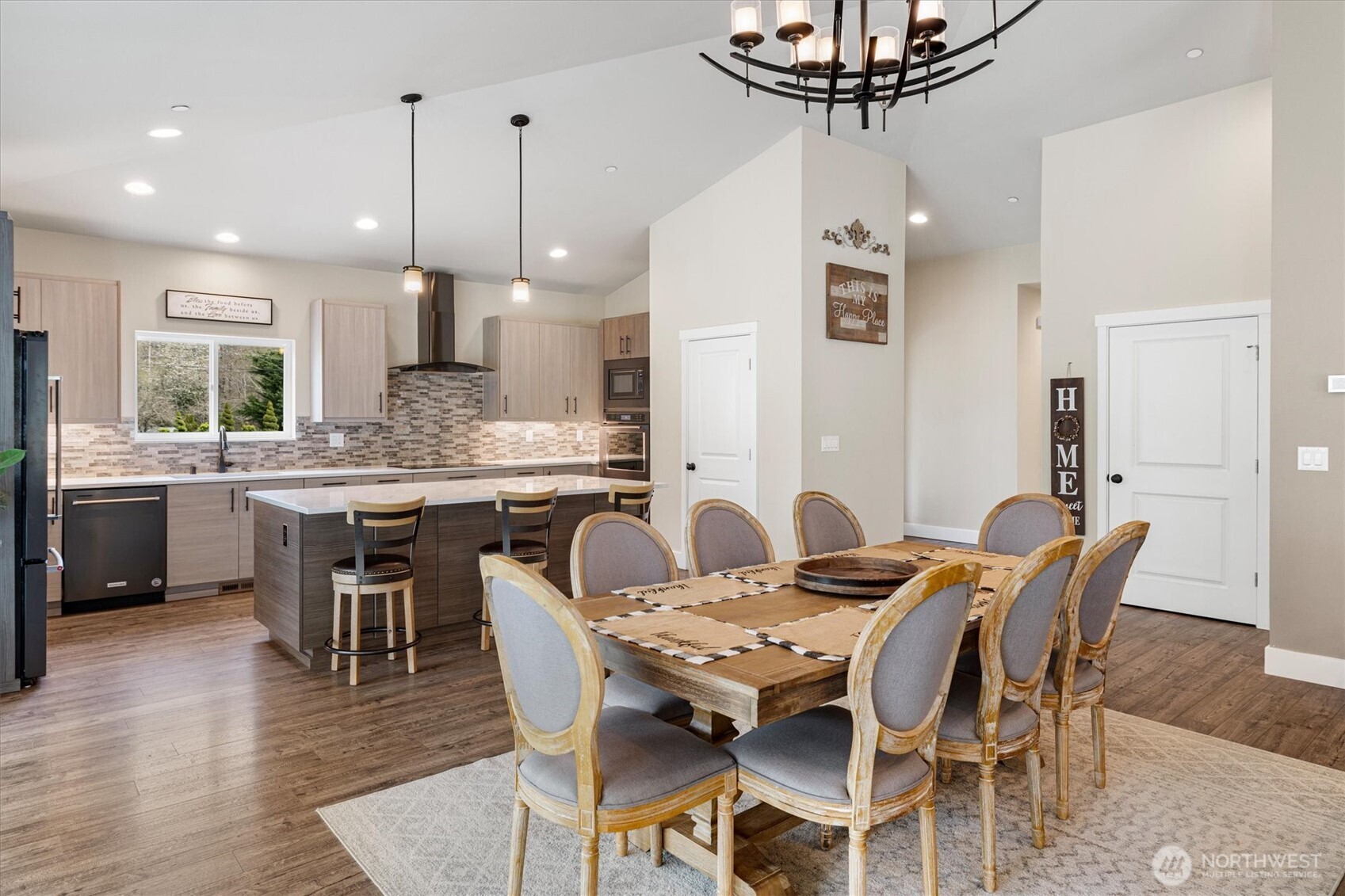 20025 Southeast 232nd Street Maple Valley, WA 98038 - Photo 12 of 40 a dining room with stainless steel appliances kitchen island a table chairs and a kitchen view