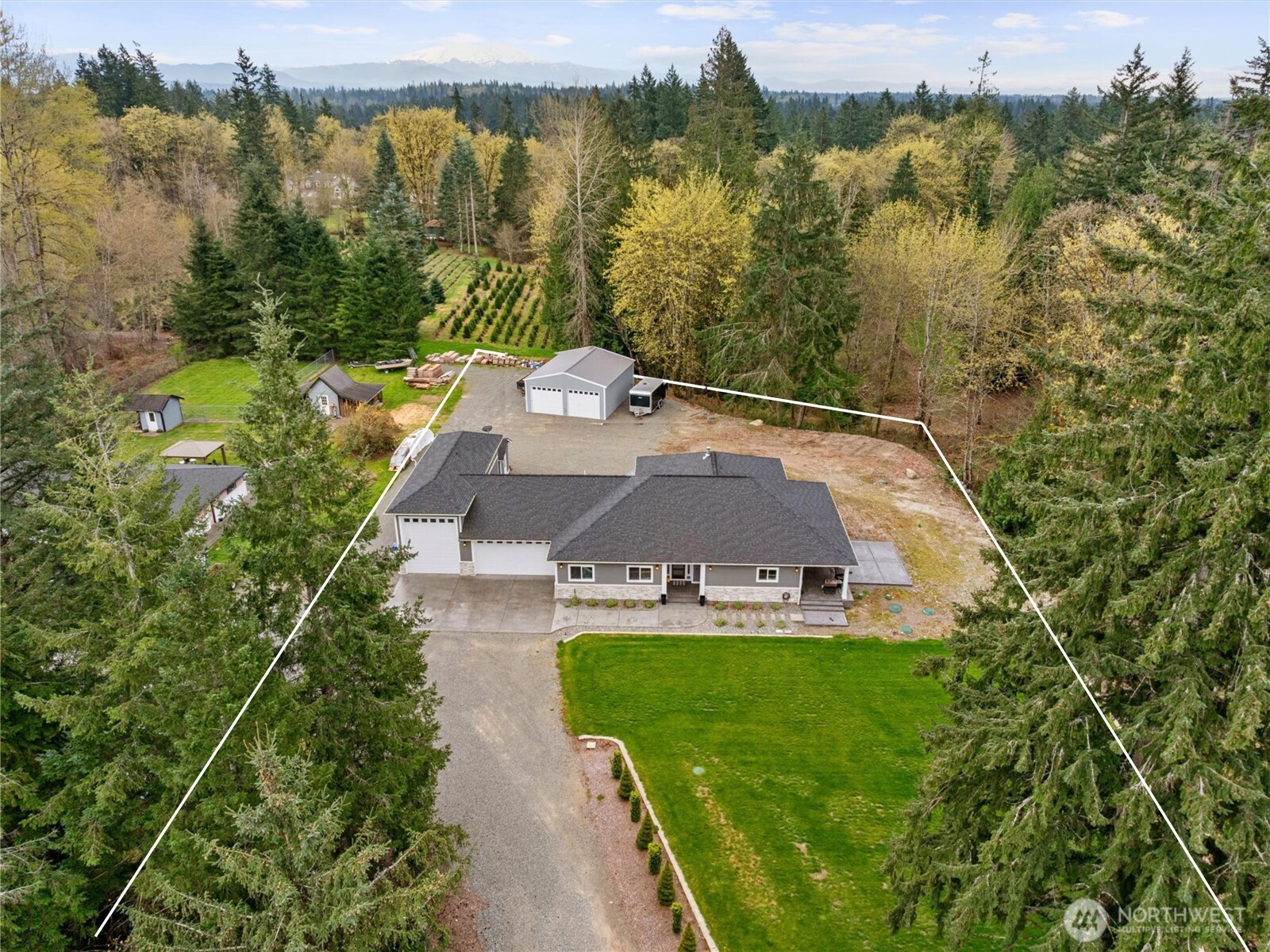 20025 Southeast 232nd Street Maple Valley, WA 98038 - Photo 2 of 40 an aerial view of a house with garden space and trees