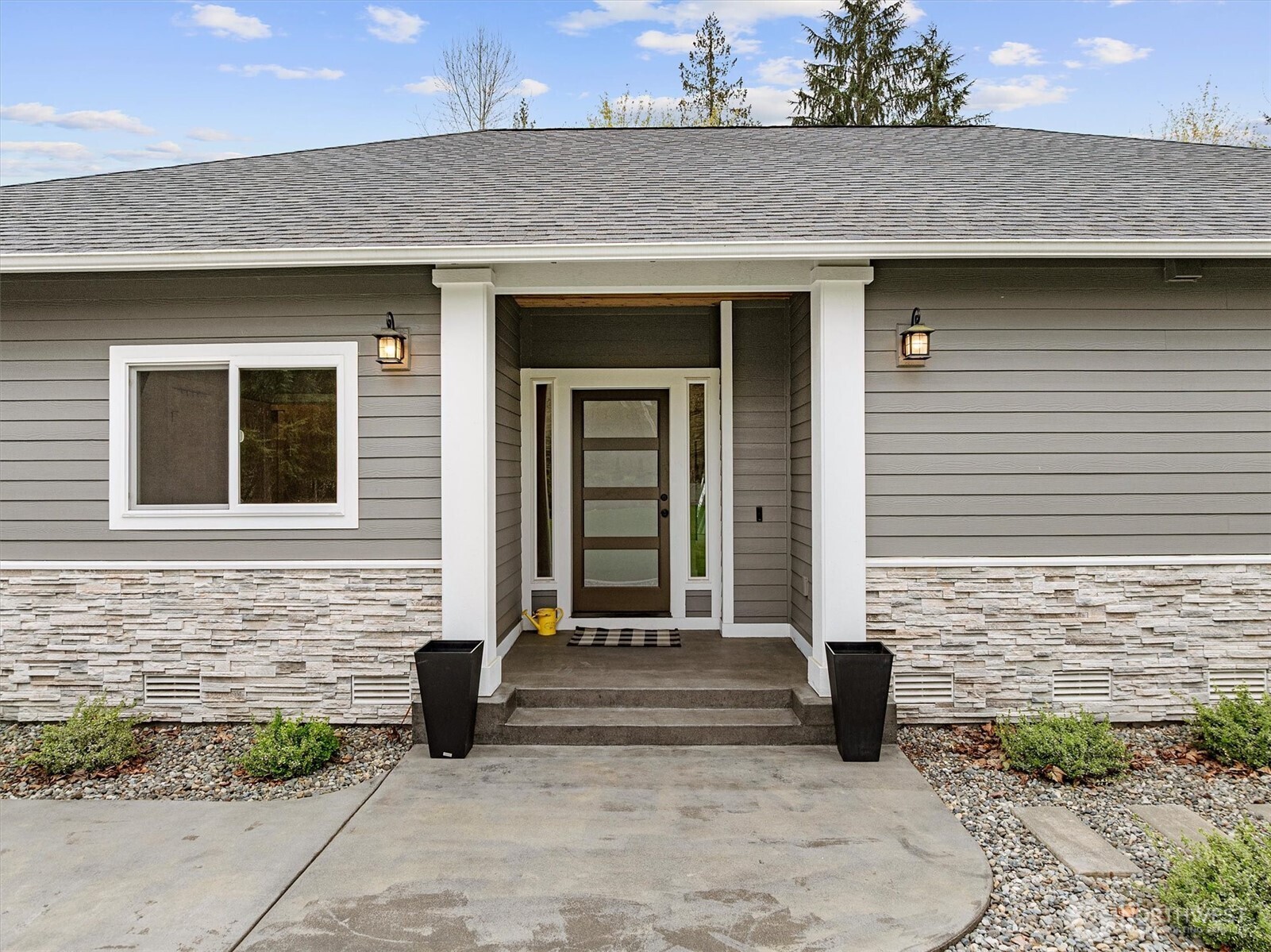 20025 Southeast 232nd Street Maple Valley, WA 98038 - Photo 4 of 40 a front view of a house with glass windows
