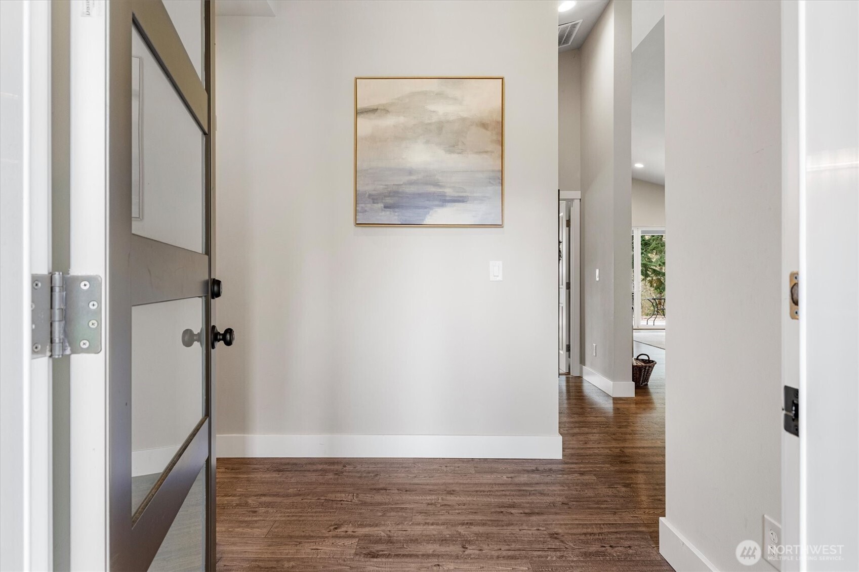 20025 Southeast 232nd Street Maple Valley, WA 98038 - Photo 5 of 40 a view of a hallway with wooden floor and staircase
