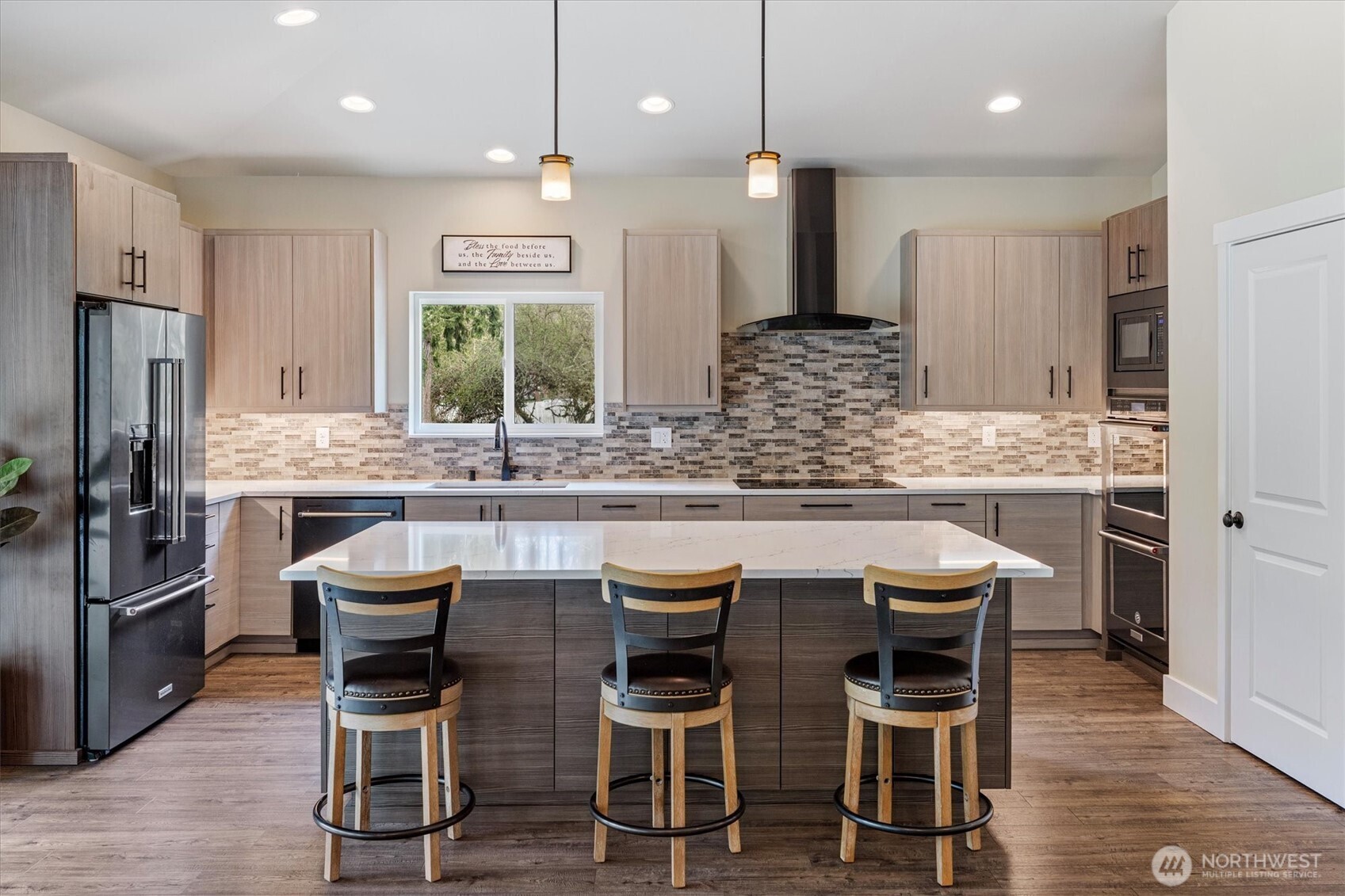 20025 Southeast 232nd Street Maple Valley, WA 98038 - Photo 8 of 40 a kitchen with stainless steel appliances granite countertop a table and chairs in it