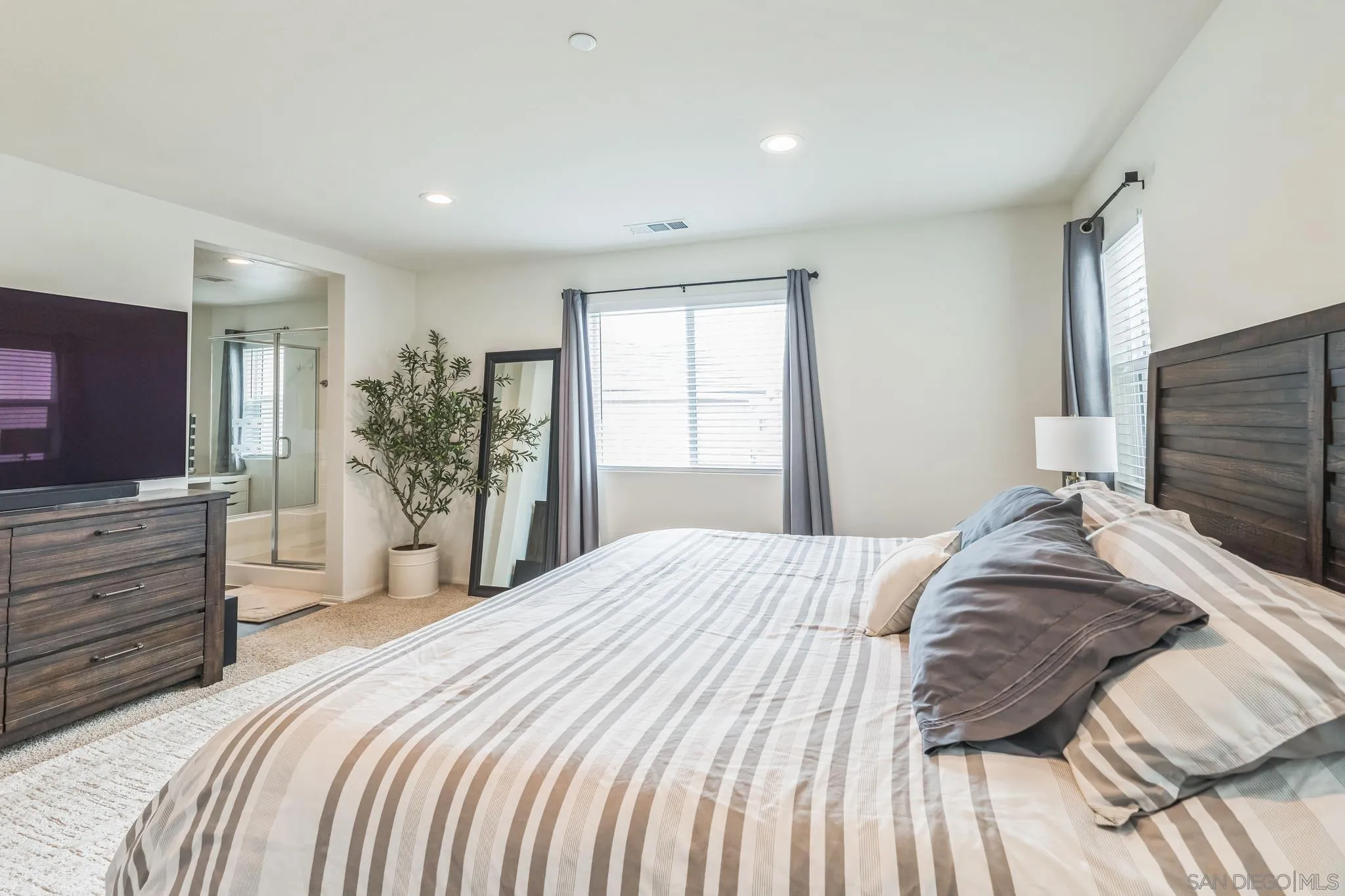 5522 Starlight Place Bonsall, CA 92003 - Photo 17 of 32 a bedroom with a bed and a flat screen tv