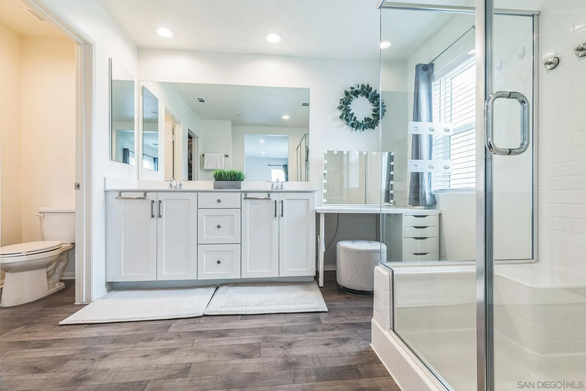 5522 Starlight Place Bonsall, CA 92003 - Photo 18 of 32 a spacious bathroom with a double vanity sink a toilet and a mirror