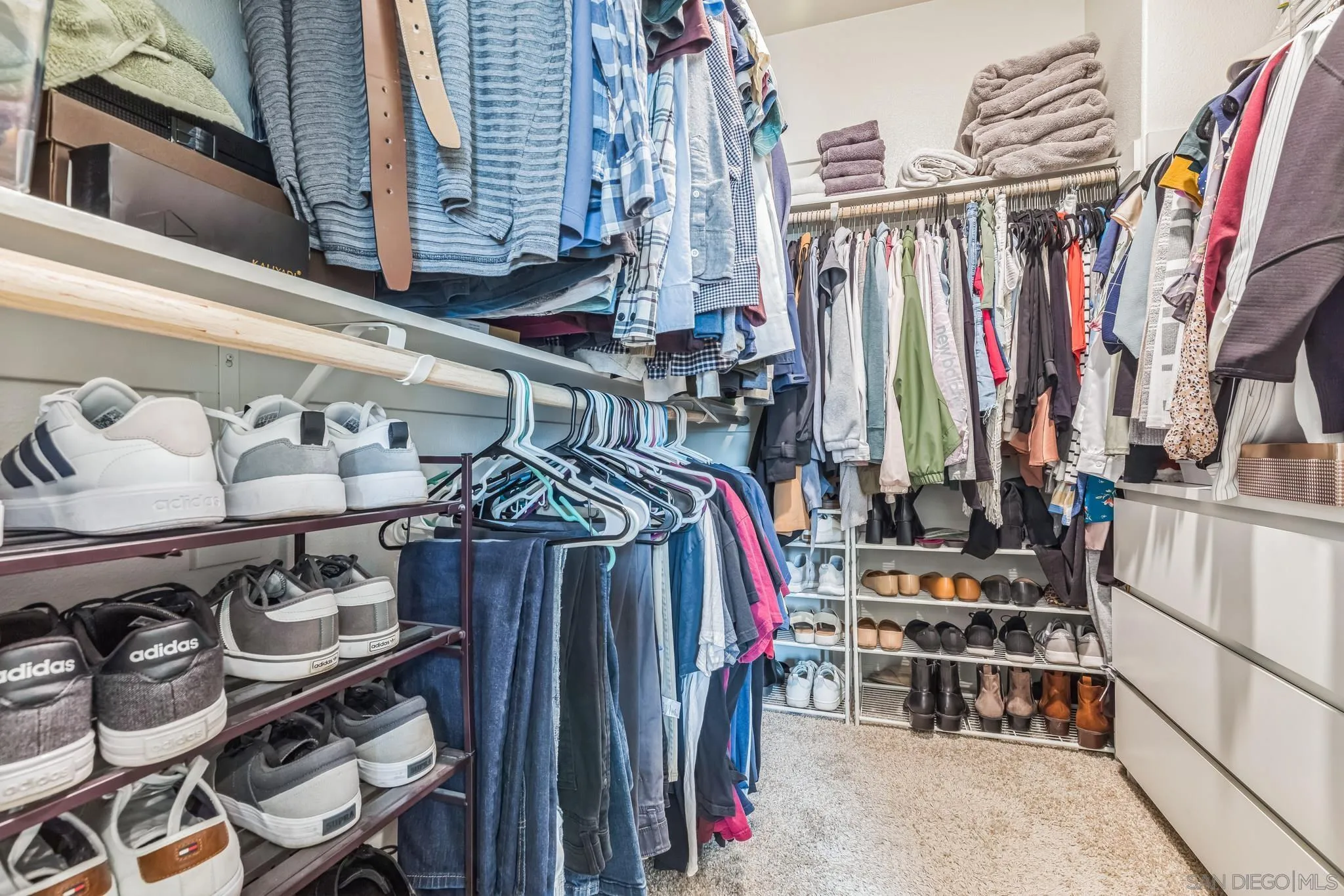 5522 Starlight Place Bonsall, CA 92003 - Photo 20 of 32 a view of walk in closet with clothes and shoes