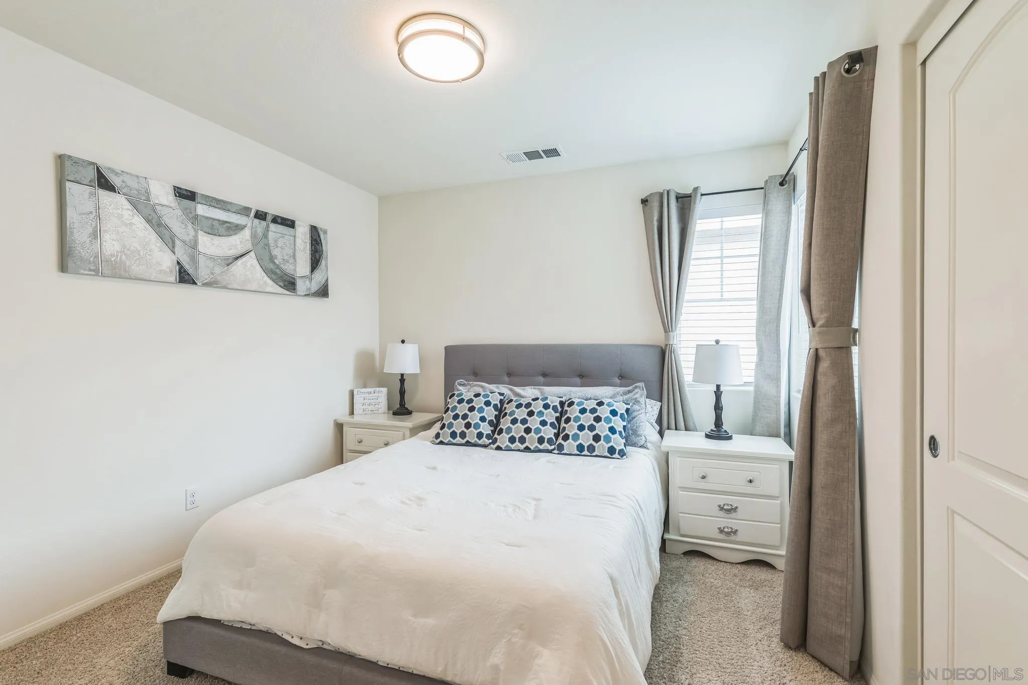 5522 Starlight Place Bonsall, CA 92003 - Photo 24 of 32 a bedroom with a bed and painting on the wall