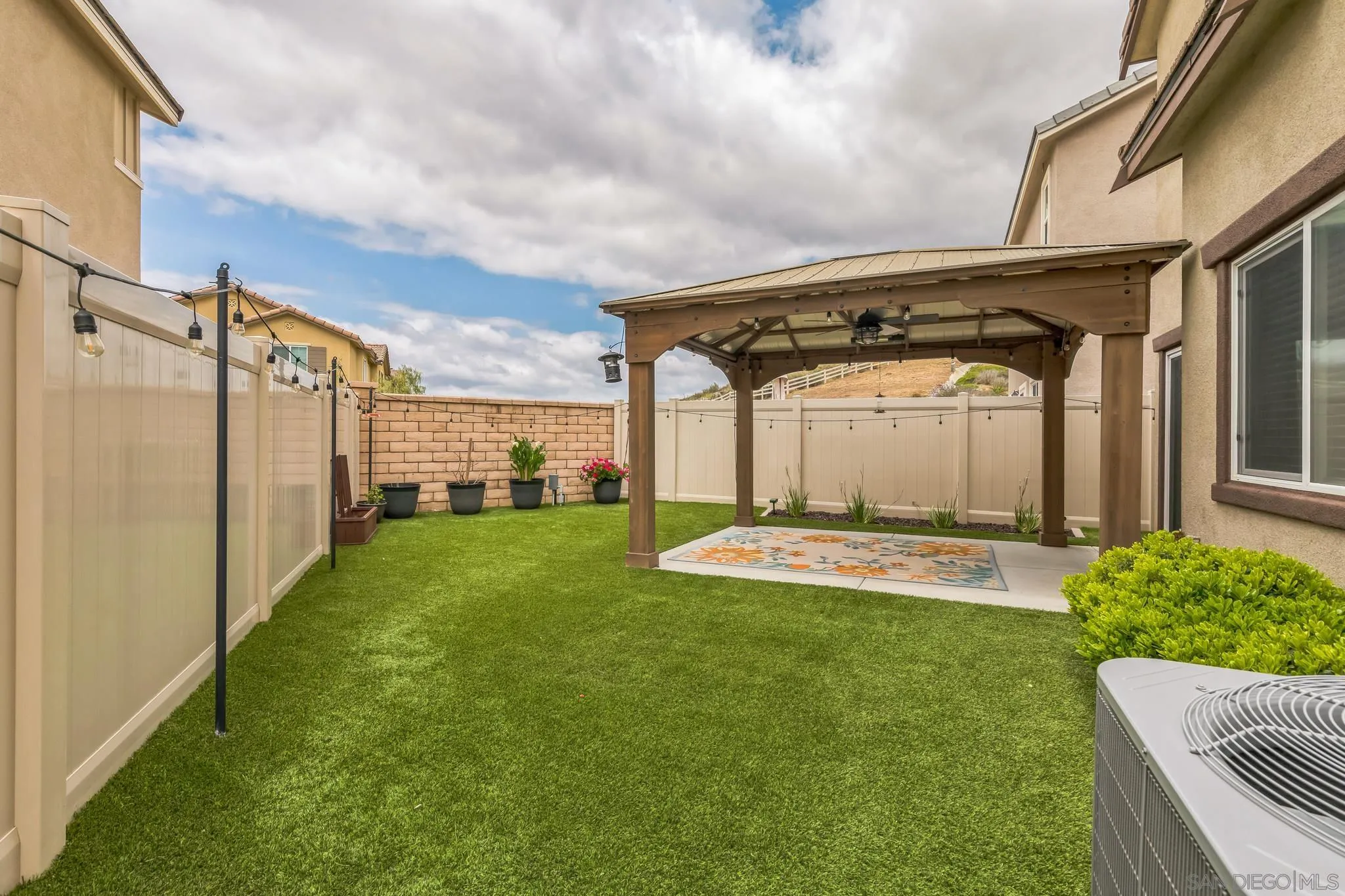 5522 Starlight Place Bonsall, CA 92003 - Photo 31 of 32 a front view of a house with a garden and yard