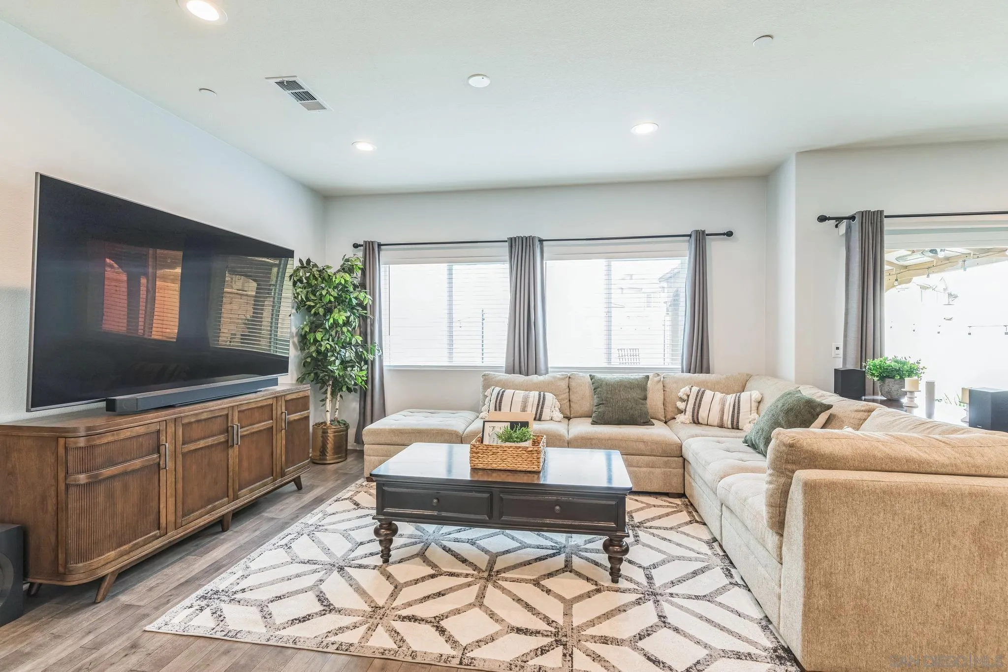 5522 Starlight Place Bonsall, CA 92003 - Photo 5 of 32 a living room with furniture a large window and a flat screen tv