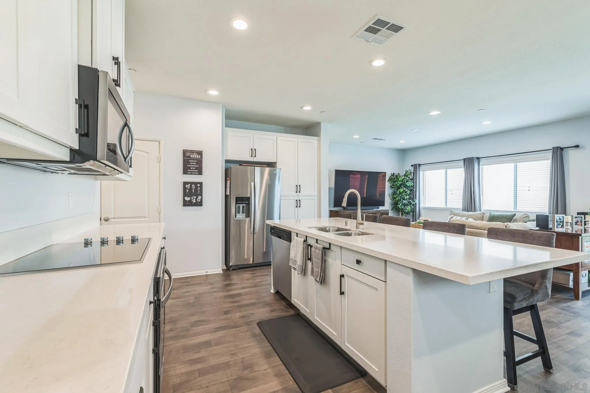 5522 Starlight Place Bonsall, CA 92003 - Photo 9 of 32 a room with stainless steel appliances kitchen island granite countertop a sink and cabinets