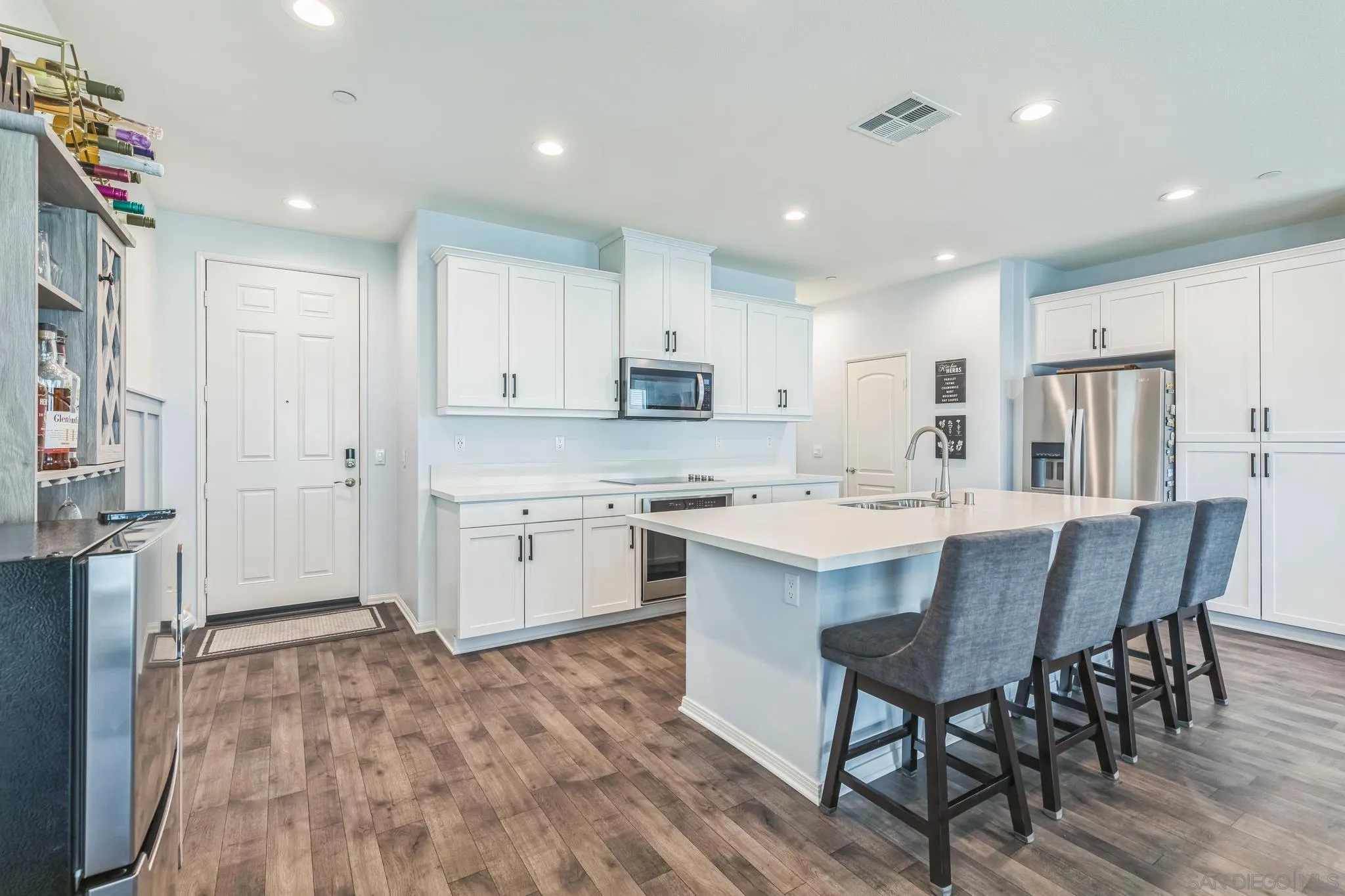 5522 Starlight Place Bonsall, CA 92003 - Photo 10 of 32 a kitchen with a sink a window stainless steel appliances and cabinets