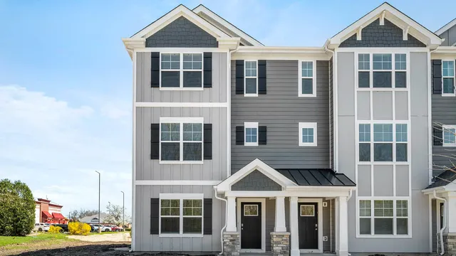 a front view of a building with a yard