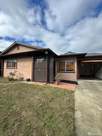 a front view of a house with a garden and yard