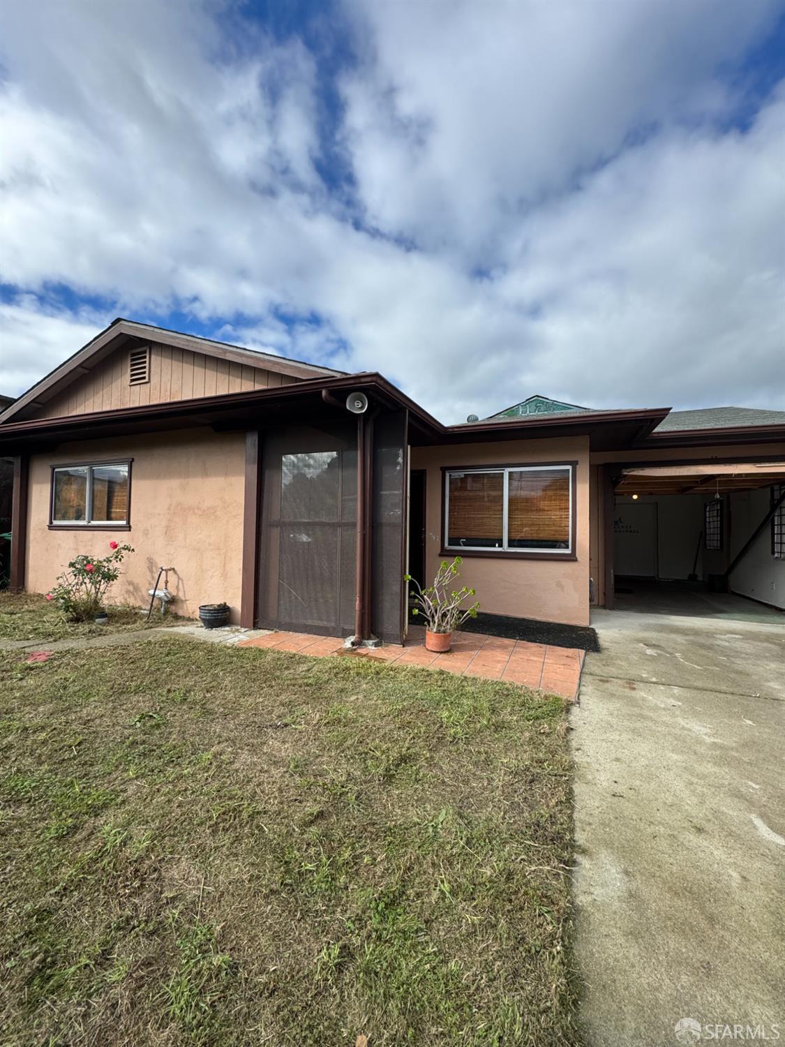 1175 Rachel Road San Pablo, CA 94806 - Photo 1 of 4 a front view of a house with a garden and yard