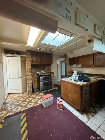 a kitchen with stainless steel appliances granite countertop a stove a sink and a refrigerator