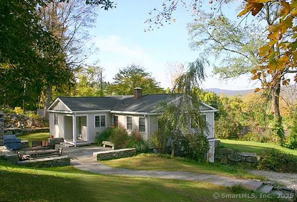 a view of a house with backyard and sitting area