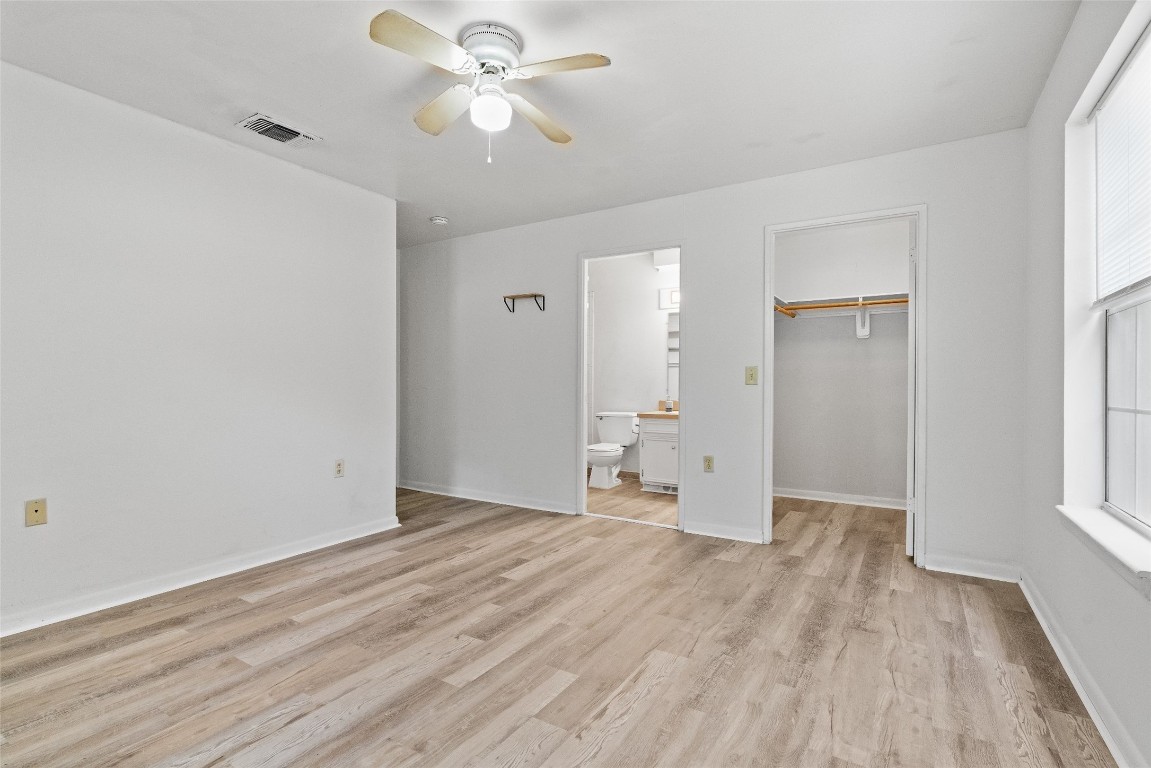 1304 Delano Street, Unit B Austin, TX 78721 - Photo 11 of 15 an empty room with wooden floor and windows