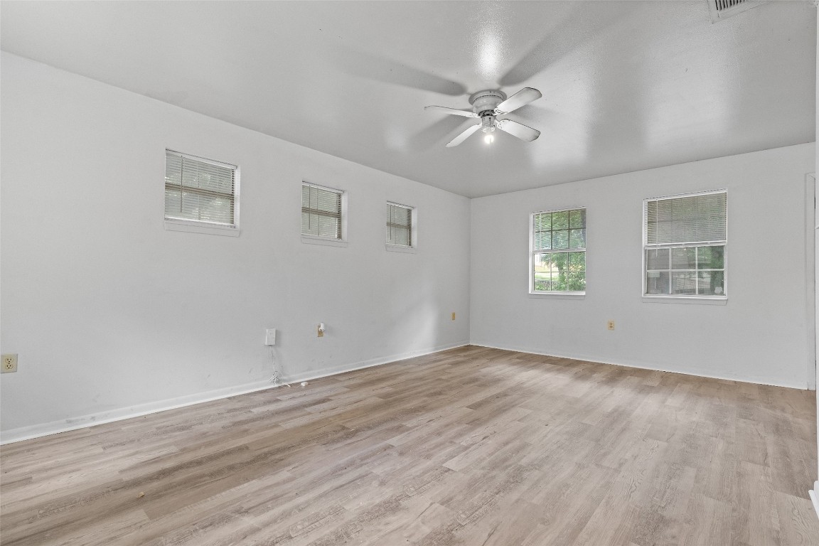 1304 Delano Street, Unit B Austin, TX 78721 - Photo 8 of 15 a view of an empty room with wooden floor and a window