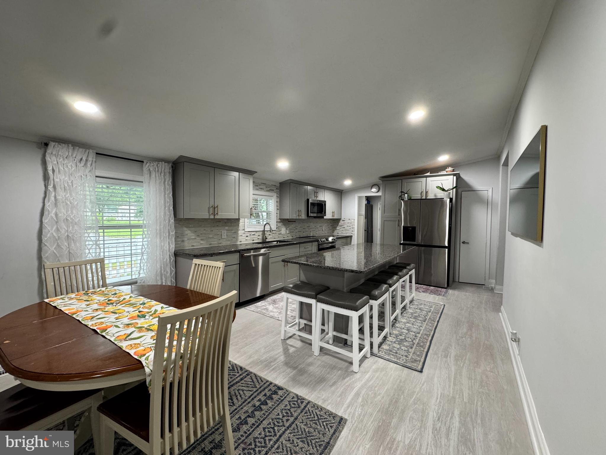 5 Emery Circle Delmar, DE 19940 - Photo 12 of 49 a kitchen with granite countertop kitchen island stainless steel appliances a sink and a refrigerator