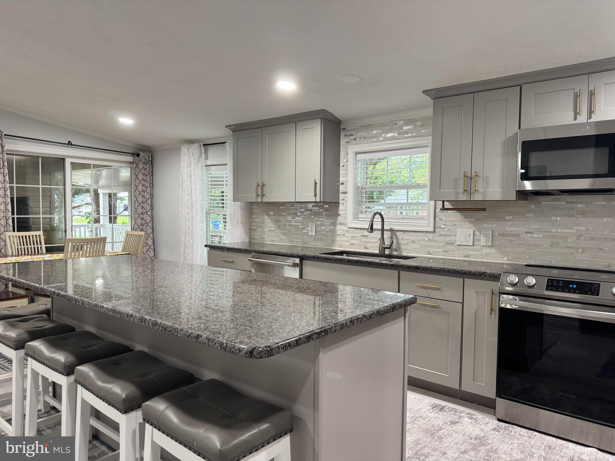 5 Emery Circle Delmar, DE 19940 - Photo 16 of 49 a kitchen with stainless steel appliances granite countertop a sink stove and microwave