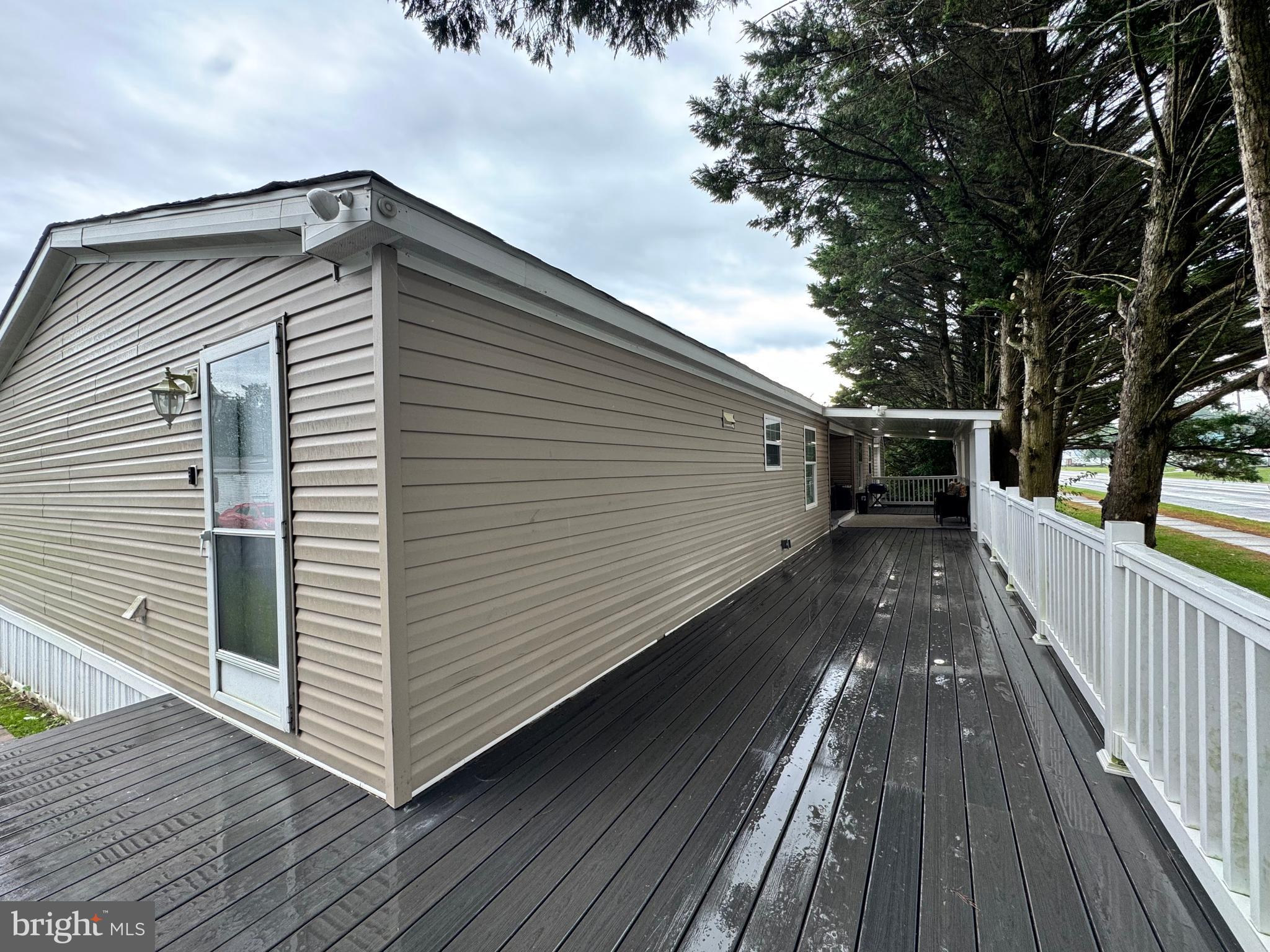 5 Emery Circle Delmar, DE 19940 - Photo 46 of 49 a view of deck with wooden floor and fence next to a yard