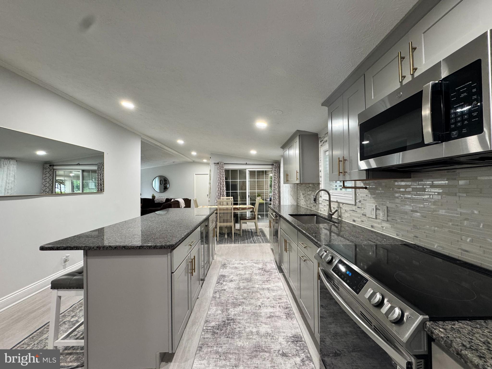 5 Emery Circle Delmar, DE 19940 - Photo 7 of 49 a large kitchen with stainless steel appliances granite countertop a lot of counter space and a sink