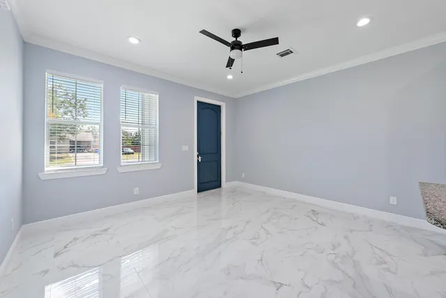 an empty room with windows and closet