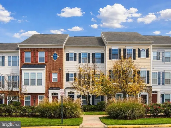 a front view of a residential apartment building with a yard