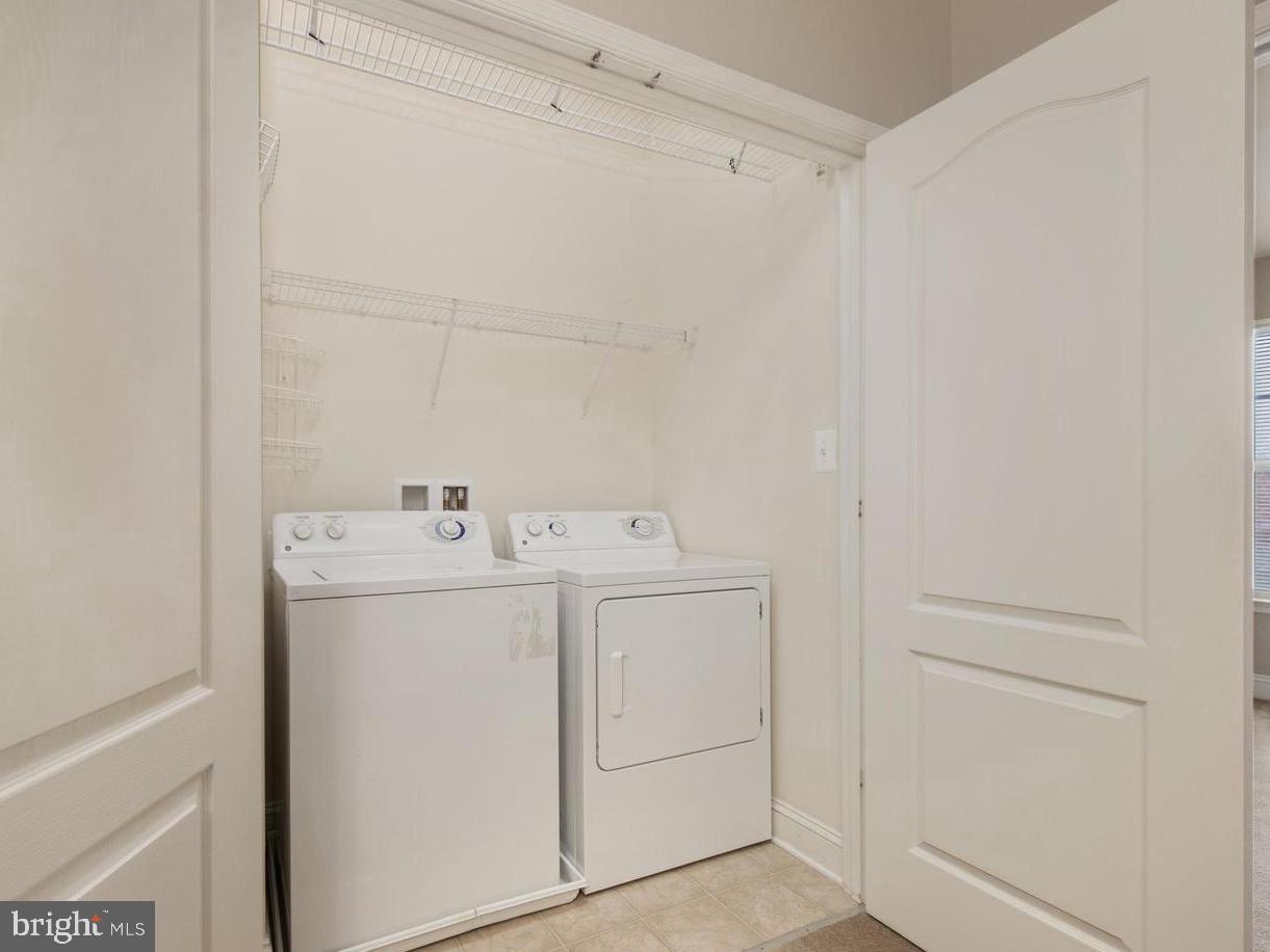 5027 Potomac Highlands Circle Triangle, VA 22172 - Photo 23 of 32 Bedroom Level Laundry with organized storage.